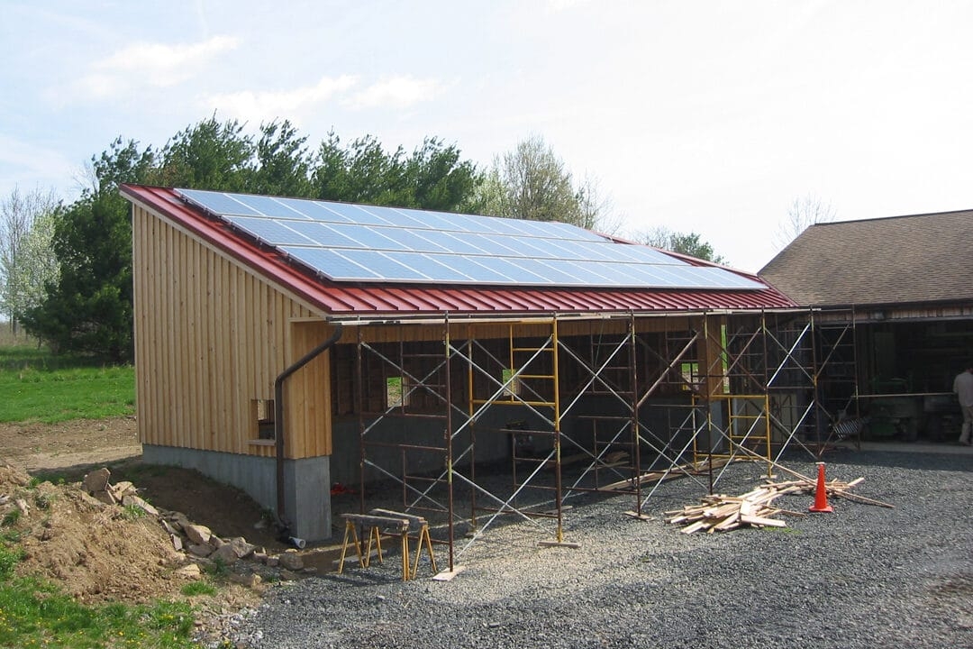 solar panels on a small wooden garage